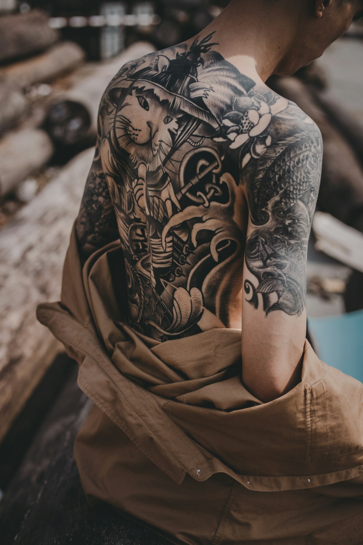 Tattoo artist making a tattoo on a client's arm